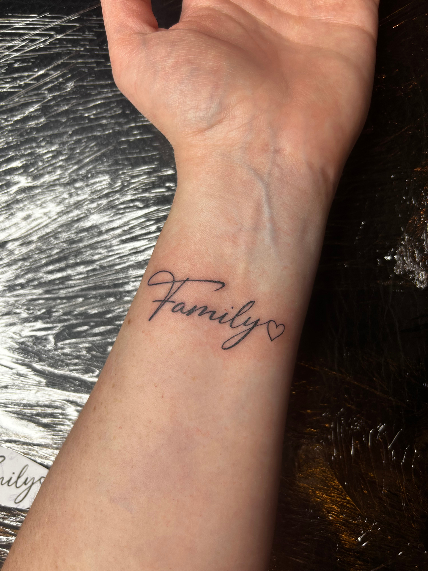 Family script tattoo
